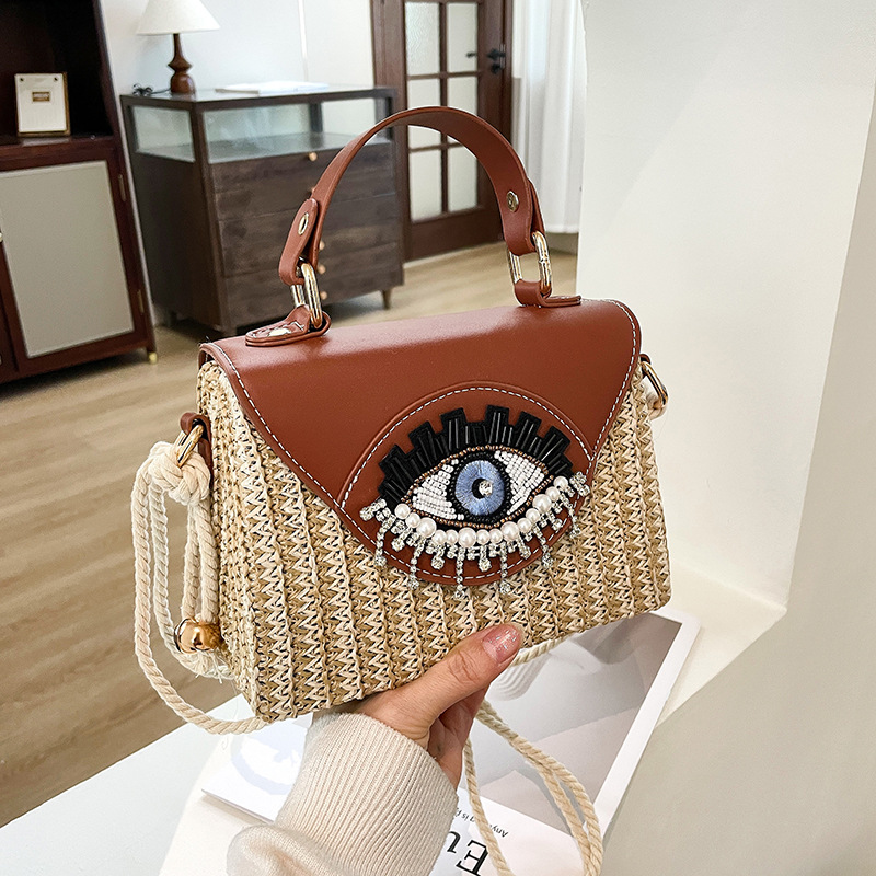 Summer woven women's bag 2025 new Japanese cartoon big eyes funny handbag versatile crossbody beach bag trend