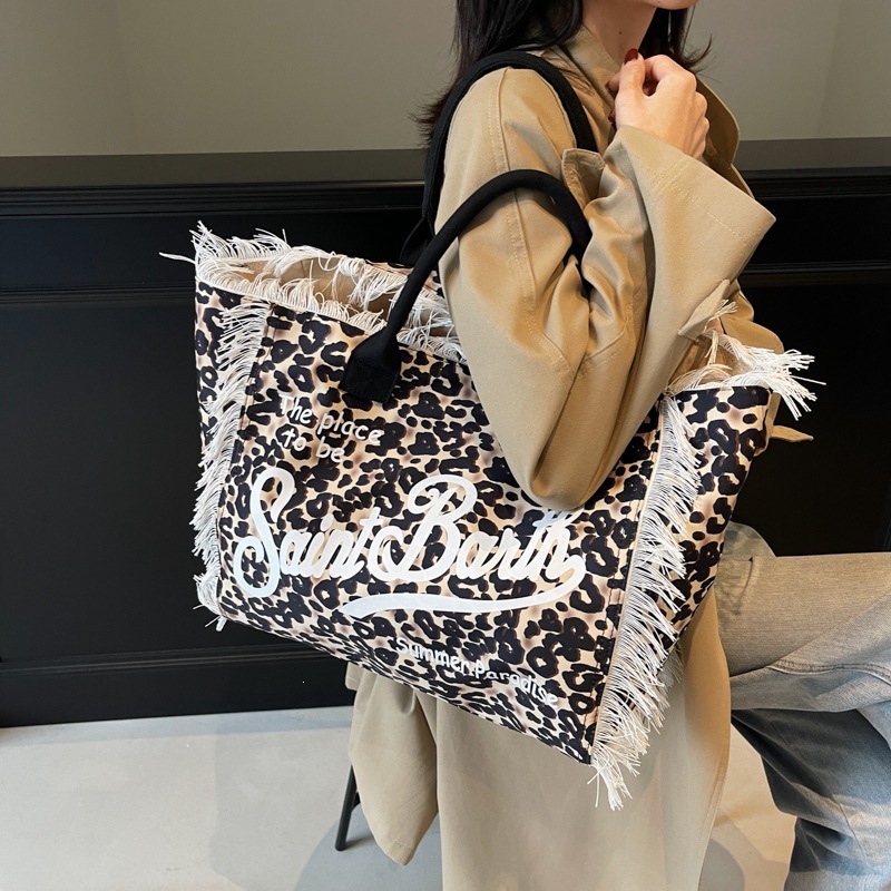 Cross border European and American handmade tassel beach canvas bag for women, 2026 new printed tote bag, large capacity shoulder bag Cross border European and American handmade tassel beach canvas bag for women, 2026 new printed tote bag, large capacity shoulder bag